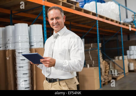 Manager using digital tablet in warehouse Stock Photo