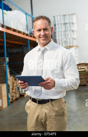 Manager using digital tablet in warehouse Stock Photo