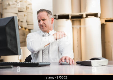 Warehouse manager suffering from shoulder pain Stock Photo