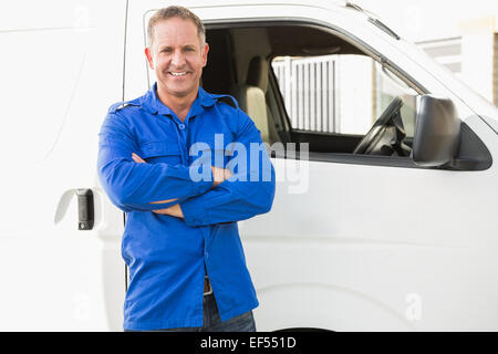 Smiling man in front of delivery van Stock Photo