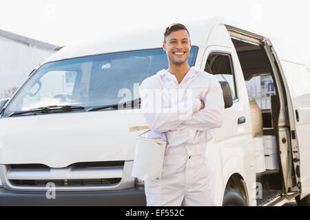 Painter smiling leaning against his van Stock Photo