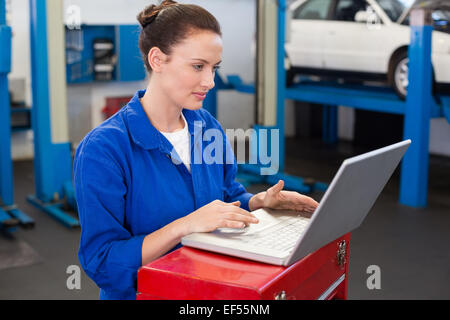 Mechanic working on a laptop Stock Photo