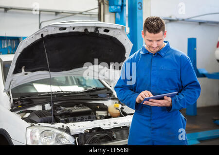 Mechanic using a tablet pc Stock Photo