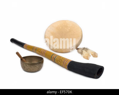 Sound Healing Instruments - Didgeridoo, Native American Drum with Feathers, and Tibetan Singing Bowl. Stock Photo