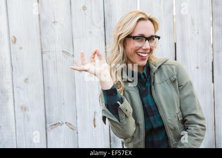 Happy blonde in glasses making okay gesture Stock Photo