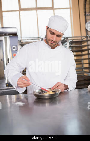 Focused baker preparing a pastry Stock Photo