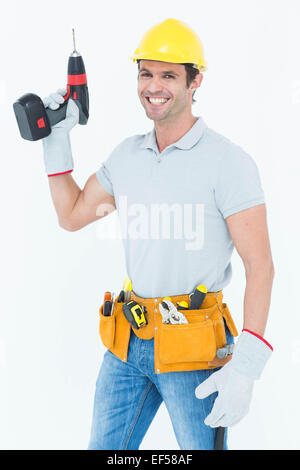 Carpenter holding cordless drill over white background Stock Photo