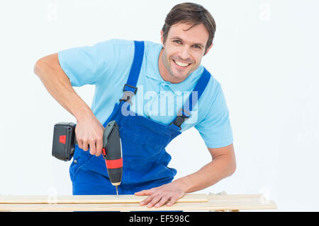 Carpenter using drill machine on wood Stock Photo