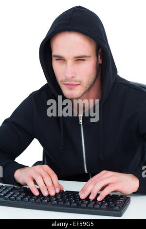 Concentrated hacker typing on keyboard Stock Photo