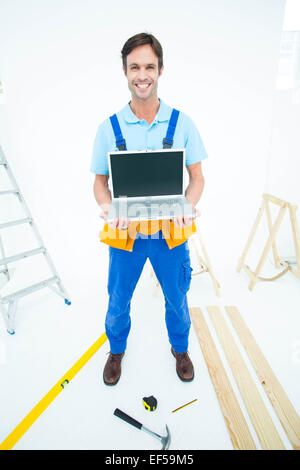 Portrait of repairman holding laptop Stock Photo
