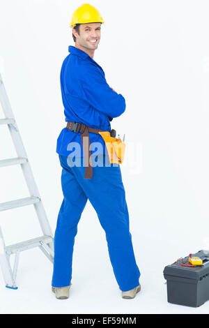 Happy electrician looking over shoulder Stock Photo