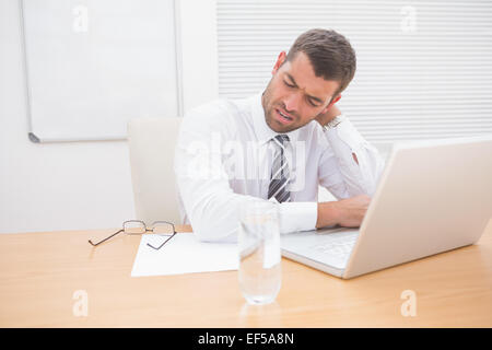 Confused businessman looking at his laptop Stock Photo