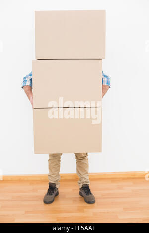 Man carrying pile of cardboard moving boxes Stock Photo