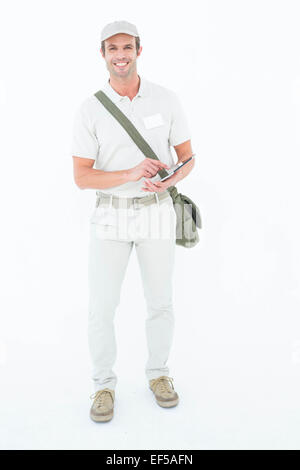 Happy delivery man using digital tablet Stock Photo