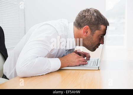 Confused businessman looking at his laptop Stock Photo