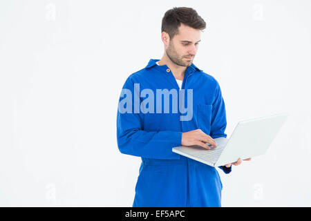 Male mechanic using laptop Stock Photo