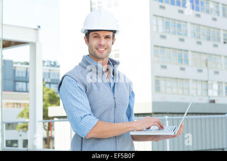 Confident male architect using laptop Stock Photo