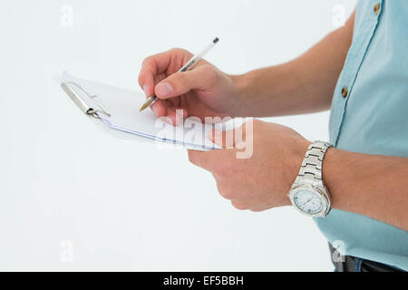 Delivery man writing on clipboard Stock Photo