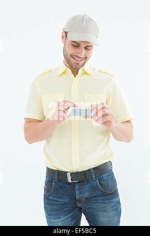 Happy courier man using mobile phone Stock Photo