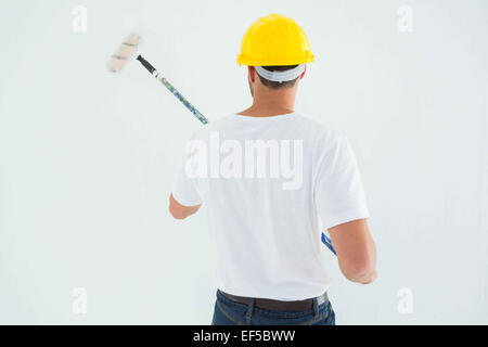 Man using paint roller Stock Photo