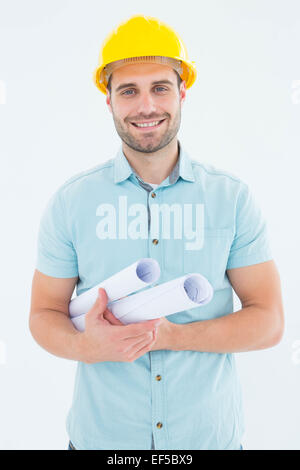 Happy male architect holding blueprints Stock Photo