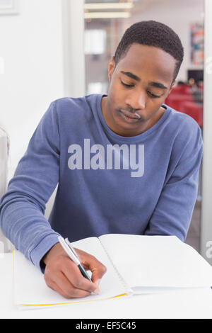 Student taking notes in class Stock Photo