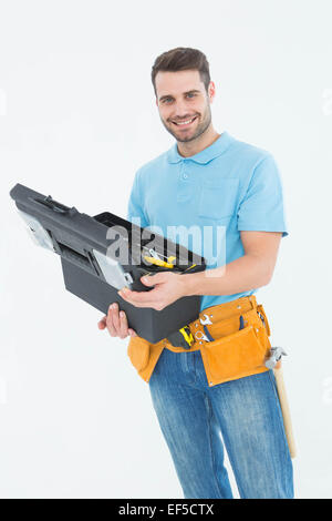 Happy construction worker holding toolbox Stock Photo