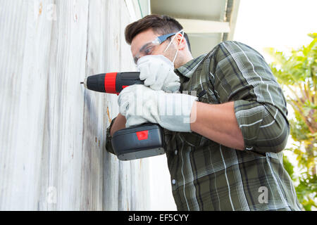 Carpenter using drill machine Stock Photo