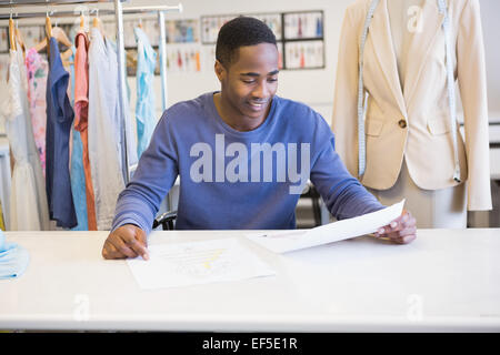 Smiling student reading page of paper Stock Photo