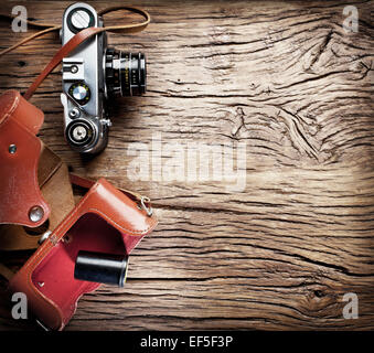 Old rangefinder camera on the old wooden table. Stock Photo