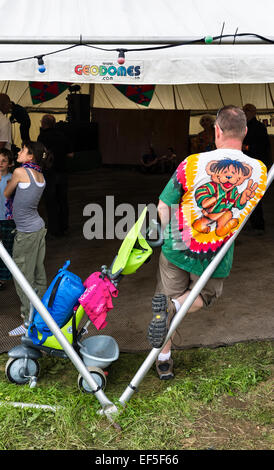 Sheep Music festival, Presteigne, Powys, UK. Man with pushchair and wearing a bright festival tee shirt Stock Photo