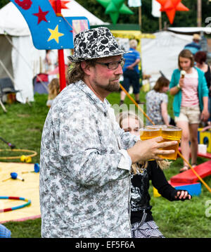 Sheep Music festival, Presteigne, Powys, UK. A festival goer carrying several pints of beer Stock Photo