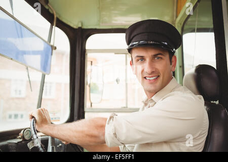 Smiling driver driving the school bus Stock Photo, Royalty Free Image ...