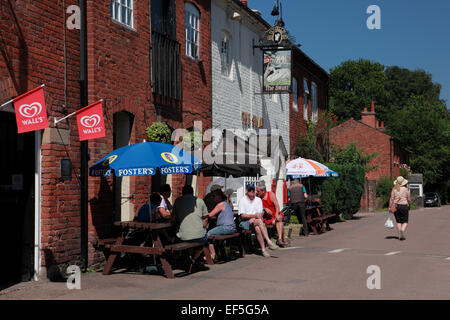 Customers outside The Swan pub at Fradley Junction where the Trent and Mersey canal joins the Coventry canal Stock Photo