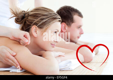 Composite image of attractive young couple having an acupunctre therapy Stock Photo