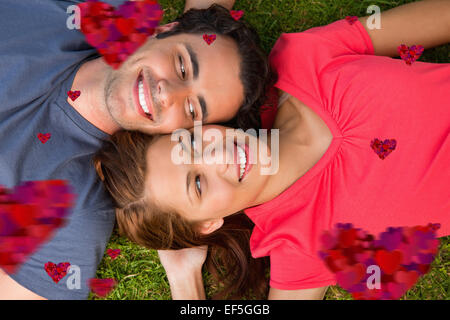 Composite image of two friends looking at each other while lying head to shoulder Stock Photo