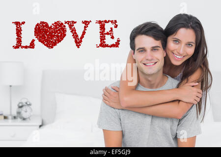 Composite image of woman embracing her partner Stock Photo
