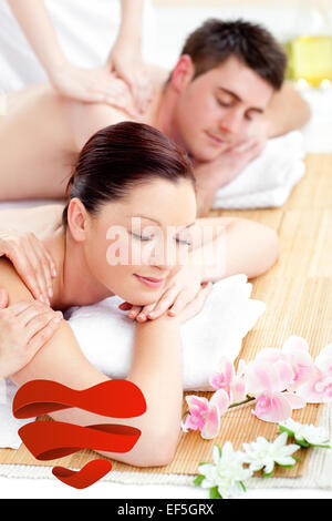 Composite image of young couple receiving a back massage Stock Photo