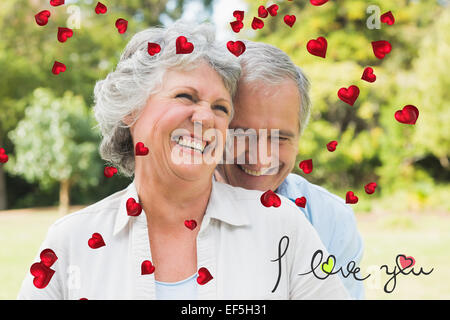 Composite image of happy mature couple laughing Stock Photo