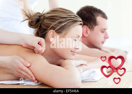 Composite image of loving couple having an acupunctre therapy Stock Photo