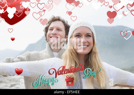 Composite image of casual young couple stretching hands out outdoors Stock Photo