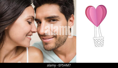 Composite image of attractive couple sitting on bed Stock Photo