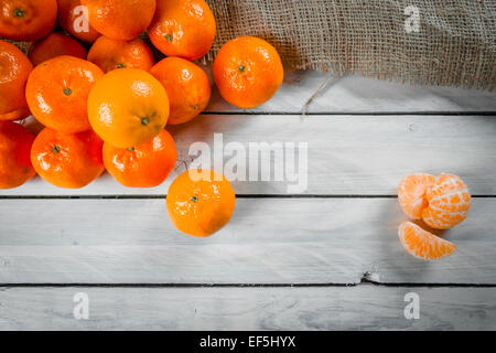 Clementine fruits on a wooden table Stock Photo