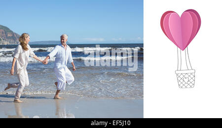 Composite image of happy couple skipping barefoot on the beach Stock Photo