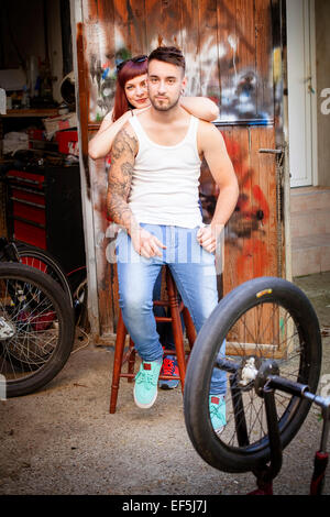 Young couple in bicycle workshop Stock Photo