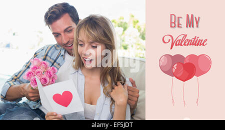 Composite image of loving couple with flowers and greeting card Stock Photo