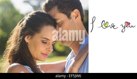 Composite image of close-up of loving couple embracing in park Stock Photo