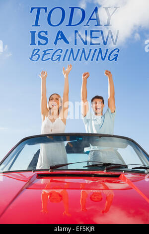 Composite image of cheerful couple standing in red cabriolet Stock Photo