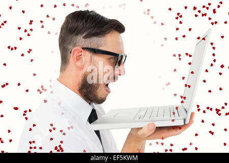 Composite image of geeky frustrated businessman looking at his laptop Stock Photo