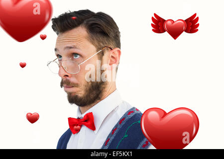 Composite image of geeky hipster wearing christmas vest Stock Photo